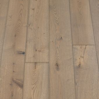 A close-up of Iron Plank flooring, featuring a rich, dark grey hue with visible wood grain. The plank has a sleek, industrial-inspired look that adds a touch of modern elegance to any interior.