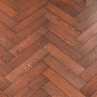 Resized Small Herring Carmine: A room set with carmine-coloured small herringbone pattern flooring from Jordan Wood Floors, featuring a deep and rich red hue.