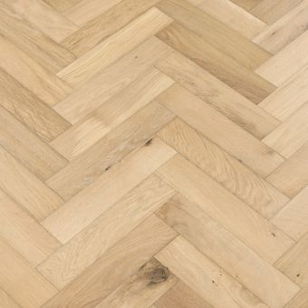 An image of small herringbone flooring in a dough finish. The flooring showcases a warm, light beige colour with subtle variations, adding a soft and neutral touch to any space.
