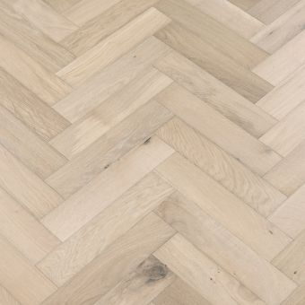 A close-up image of small herringbone flooring in a granite finish. The pattern features a mix of light and dark grey tones, creating a sophisticated and modern look.
