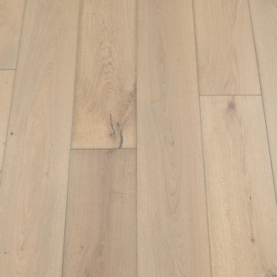 A photograph of a sand-coloured plank flooring. The planks feature a light, sandy hue with natural wood grain patterns, providing a warm and inviting appearance.